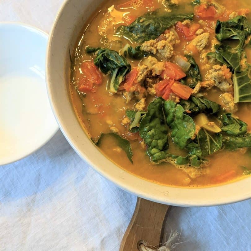 Top down view of a bowl containing delicious turkey chard soup for pregnancy.