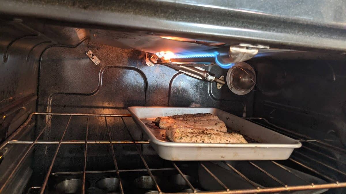 Wild Alaskan Apple Maple Salmon on a rimmed baking sheet in the oven.