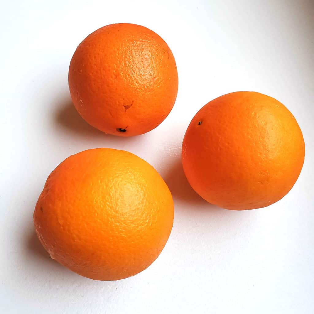 three orange fruits