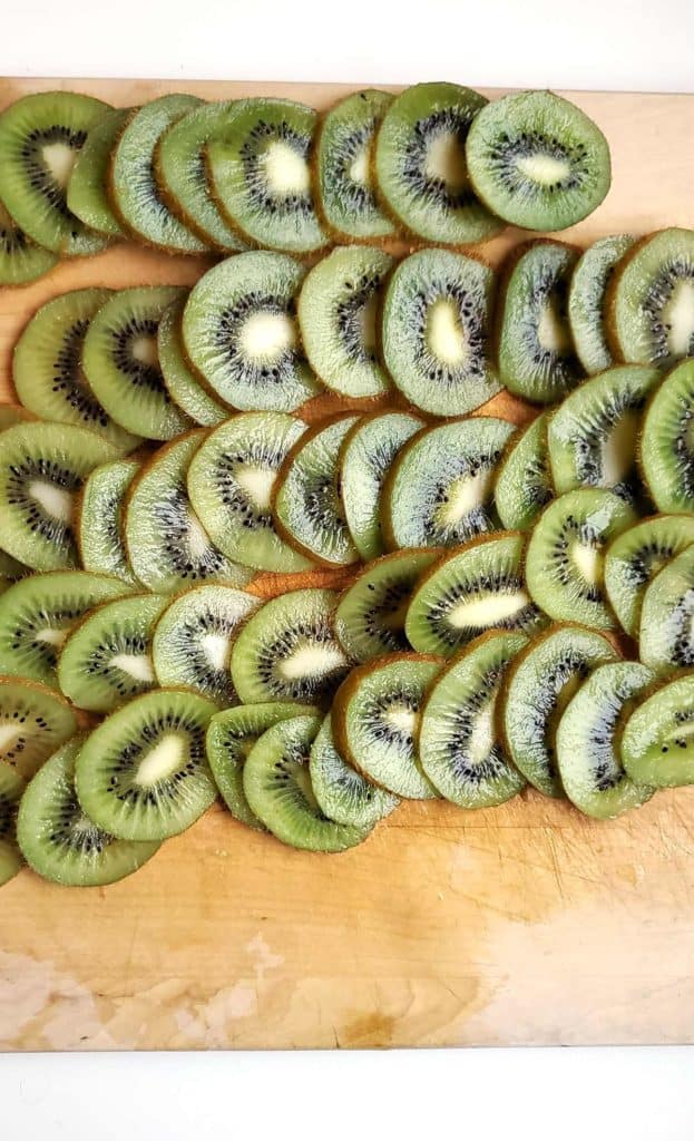 Pile of Sliced Kiwis on Wooden Board