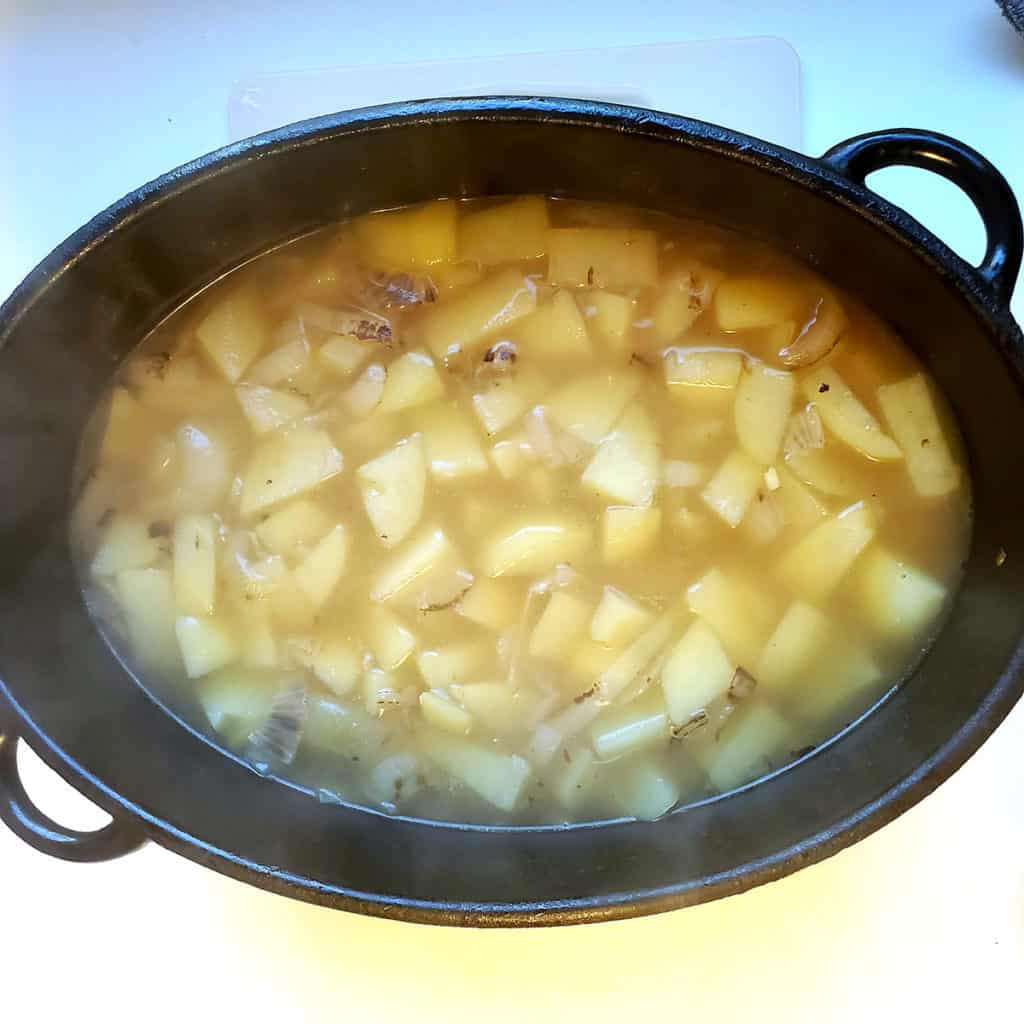 Chopped potatoes in soup pot