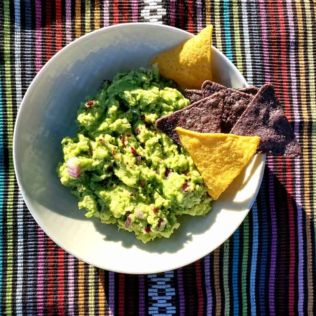 4-Ingredient Guacamole in Bowl with Colorful Corn Chips