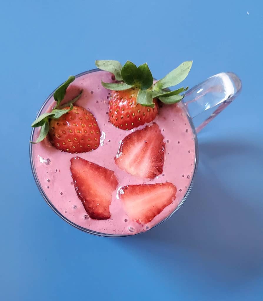 Birds eye view of blackberry banana strawberry smoothie in mug.