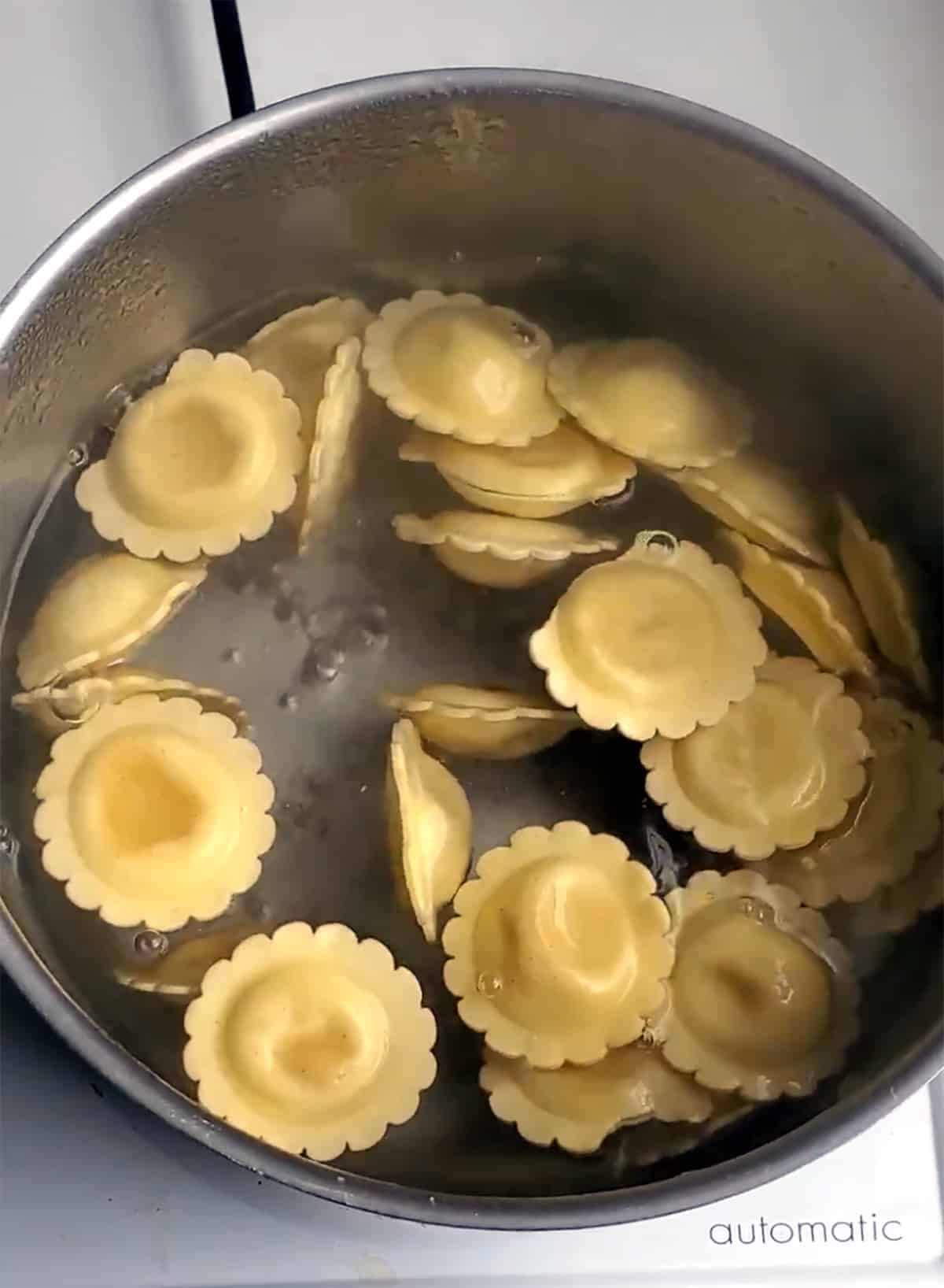 Boil cheese ravioli in pot of boiling water.